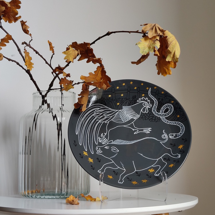 Decorative ceramic plate "Pig, Rooster, and Snake" from the series "The Chase"